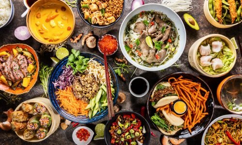 Top view composition of various Asian food in bowls, free space for text