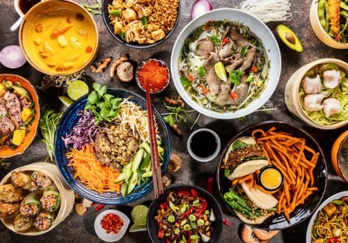 Top view composition of various Asian food in bowls, free space for text